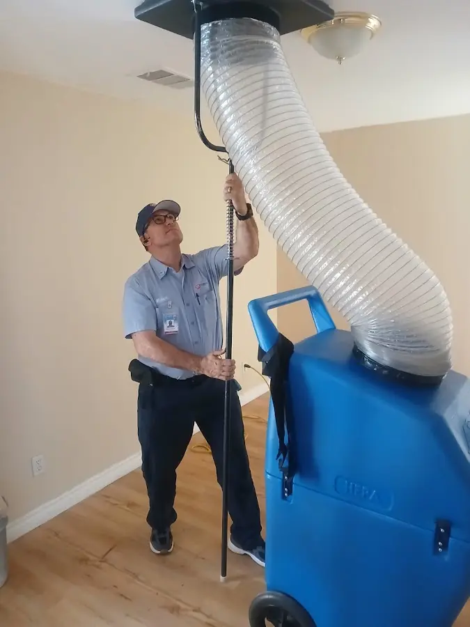 Furnace Tune-Up technician using HEPA equipment in Lino Lakes